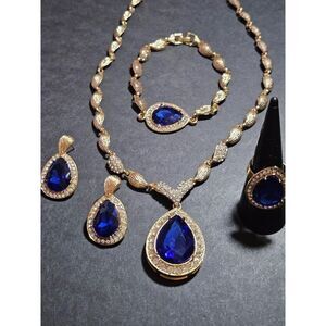 Gold tone blue rhinestone necklace, bracelet, earring and ring set